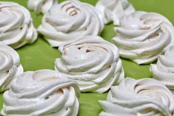 Freshly made marshmallows lie on the surface of the table. It is stabilizing