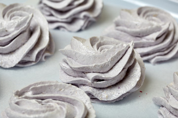 Freshly made marshmallows lie on the surface of the table. It is stabilizing