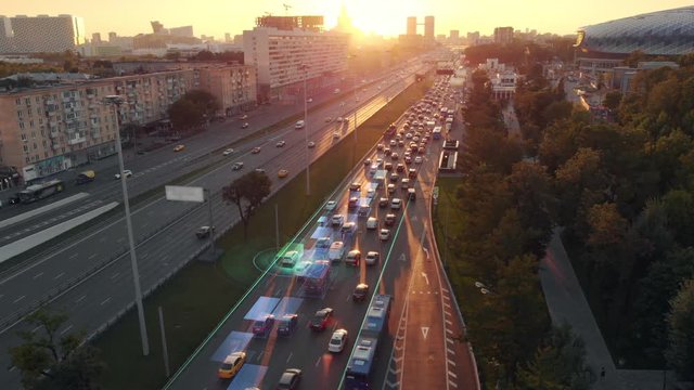 Amazing aerial presentation of the autonomous cars self-driving concept on the sunny evening in Moscow. Beautiful view from above to the road traffic on multi-level highway of big city.