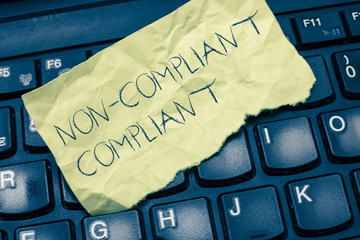 Text sign showing Non Compliant Compliant. Conceptual photo Resistant to the Rule in Accordance to...