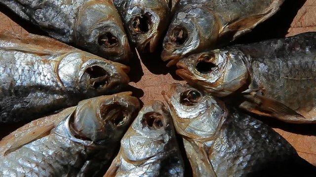 dried salt fish wooden background 
