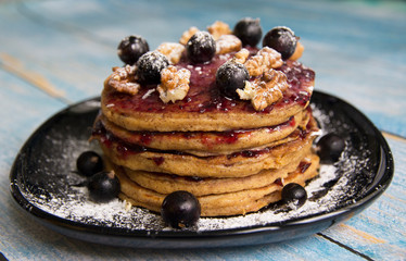 Pancake with currant jam and currant berries