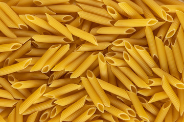 Group of penne rigate shape of italian pasta as background banner