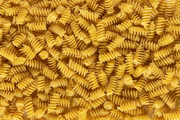 Spiral rotini shape of italian pasta as background banner