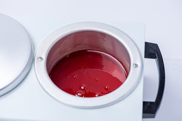 Preparation of wax for shugaring. Closeup of depilation wax on white background