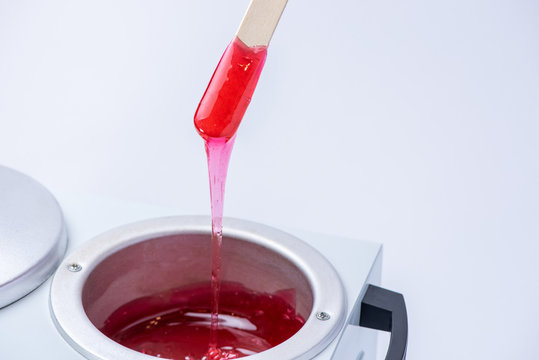 Preparation Of Wax For Shugaring. Closeup Of Depilation Wax On Wooden Stick On White Background