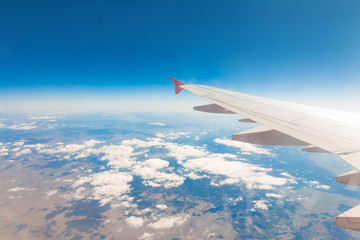 Fototapeta premium Wing of an airplane. Traveling concept. Aircraft wing on the clouds