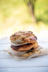 Stack of flatbread on a table outdoors. Flapjack, street food.