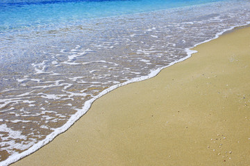 Wave on sandy beach background