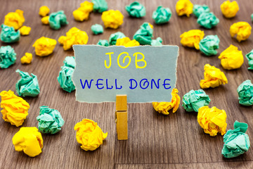 Fototapeta premium Text sign showing Job Well Done. Conceptual photo Well Performed You did it Cheers Approval Par Accomplished Clothespin holding gray note paper crumpled papers several tries mistakes