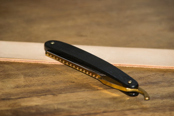 Clasic straight razor on wodden background