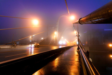 Lonely car on wet asphalt road by night