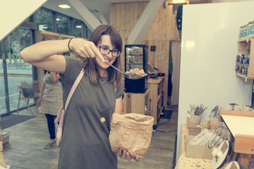 Happy female customer picking some delicious candies.