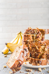 Homemade banana bread with walnuts, gray stone concrete background copy space, Vegan food.