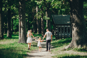 Happy family with two children have rest on a walk outdoors.