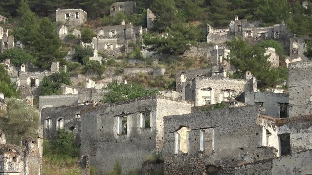 Kayakoy, Fethiye, Turkey - 12th of June 2019: 4K Zoom out ruining town of Kayakoy summer panorama