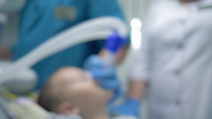 general anesthesia, patient is in a state of sleep after inhaling into mask for anesthesia in operating room for treatment, the form is not in focus