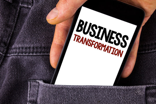 Conceptual hand writing showing Business Transformation. Business photo text Making changes in conduction of the company Upgrade written Mobile Phone holding by man the Jeans background.