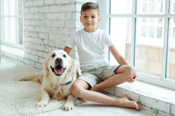 A child with a dog. Teen boy with a dog at home.  © nuzza11
