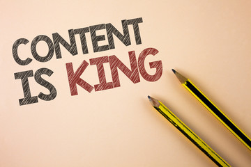 Writing note showing Content Is King. Business photo showcasing articles or posts can guarantee you success Advertising written Plain background Pencils next to it.