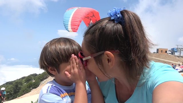 1700 m Babadag mountain peak, Fethiye, Turkey - 12th of June 2019: 4K Excited mother and child make selfie at the parachute jumping point