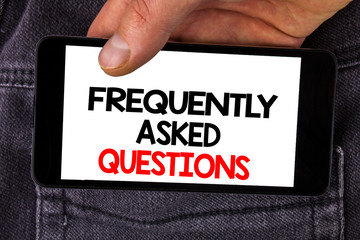 Writing note showing Frequently Asked Questions. Business photo showcasing most common inquiries Informations Help Guide written Mobile Phone Screen holding by man the Jeans background.
