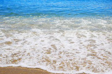 Wave on sandy beach background