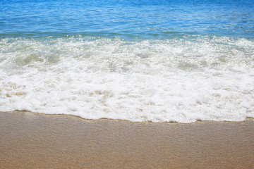 Wave on sandy beach background