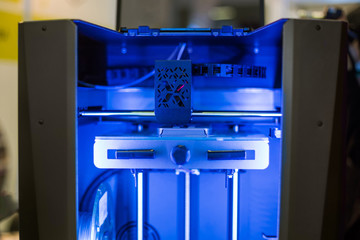 Three dimensional printer during work at 3d science technology exhibition. 3D printing, additive technologies, engineering and prototyping industry concept