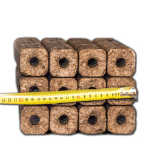 Fuel briquettes folded in rows on a white background.