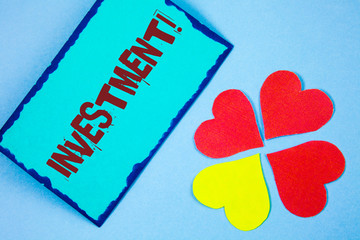 Text sign showing Investment Motivational Call. Conceptual photo To put Money Time into something to make profit written Sticky Note paper plain background Paper Love Hearts next to it.