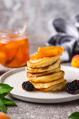 Pancakes with apricot jam and berry