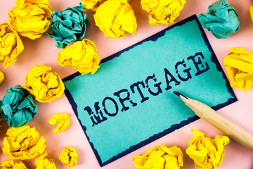 Text sign showing Mortgage. Conceptual photo Conditional right of property to lender as warranty from loan written Sticky Note paper within Paper Balls plain background Pencil.