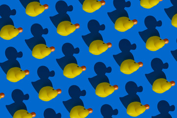Fototapeta na wymiar Pattern yellow rubber ducks and shadows