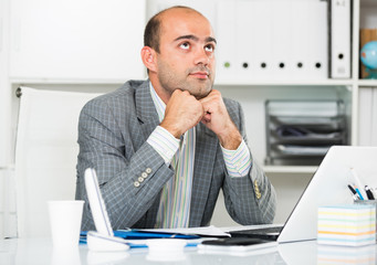 Naklejka premium Sad businessman thinking about work