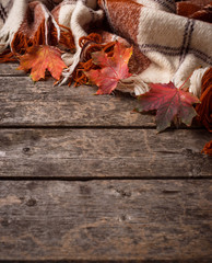 Naklejka na ściany i meble Autumn background with plaid and leaves