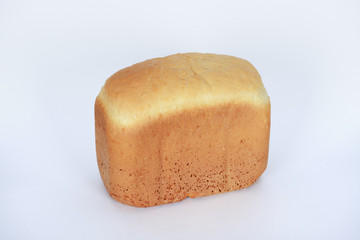 The hand-made bread made in bread baking machine on white background