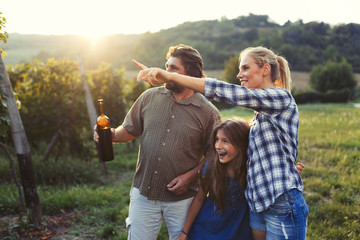Picture of people tasting red wine in vineyard