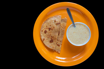 Egg Paratha with Dalia or Daliya, Cereal Food Know as Bulgur Cooked in Milk Served with Egg Stuffed Paratha or Indian Stuffed Bread with Egg or Fried Flatbread, Selective focus.