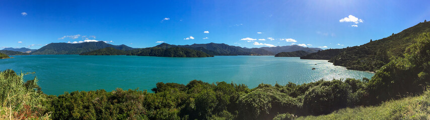 A sweeping panoramic view of the beautiful Marlbough Sounds, New Zealand, sparkling waters, clear blue skies