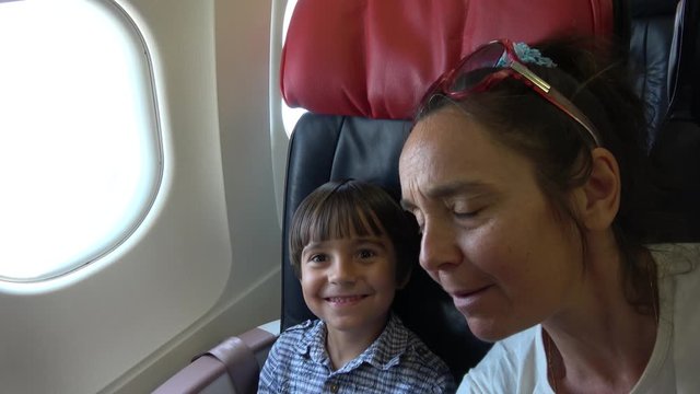 Dalaman Airport, Turkey - 18th of June 2019: 4K Selfie of mother and son in the plane