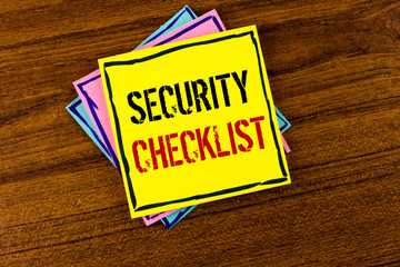 Writing note showing Security Checklist. Business photo showcasing list with authorized names to enter allowing procedures written Yellow Sticky Note Paper the Wooden background.