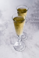 Glasses full of champagne on concrete surface