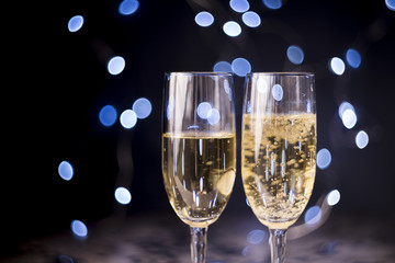 Two champagne glasses on bokeh background