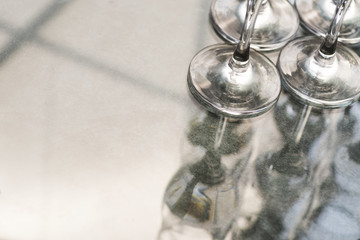 Transparent wineglasses on reflective background
