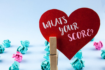 Handwriting text What Is Your Score Question. Concept meaning Tell Personal Individual Rating Average Results written Red Paper Heart holding by Clip plain background Paper Balls next to it.