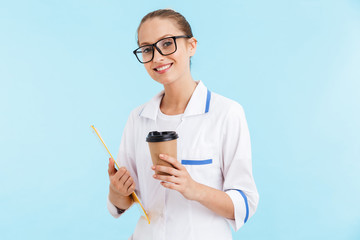 Beautiful blonde woman doctor wearing uniform standing