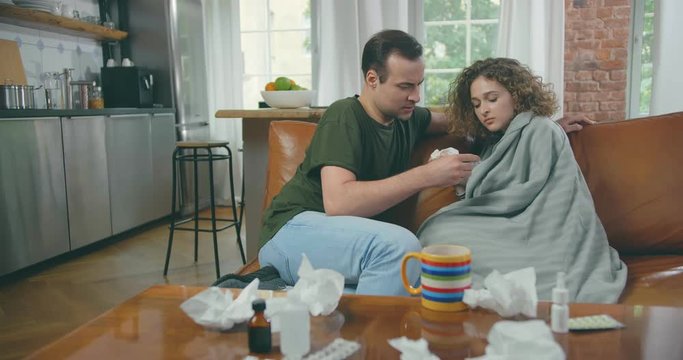 Young adult husband take care of his sick wife