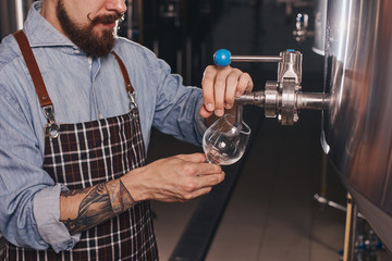 Close up of bartender at work pouring beer.