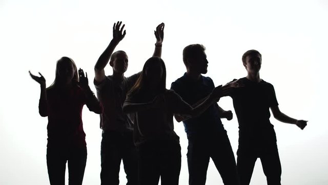Silhouettes of people dancing together on a white background